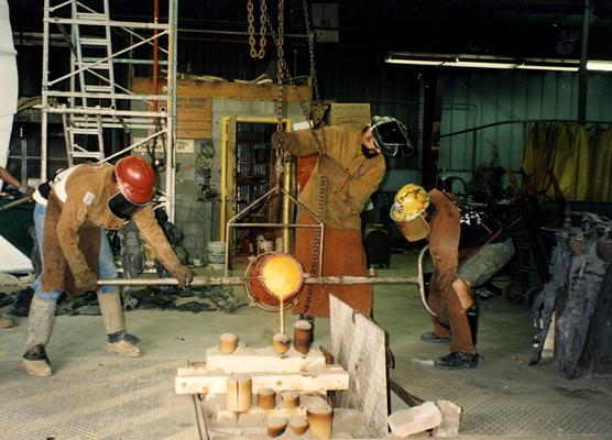 Scott Oberlink, Jack Gron and Andrew Marsh pouring bronze at the University of Kentucky foundry for the casting of 