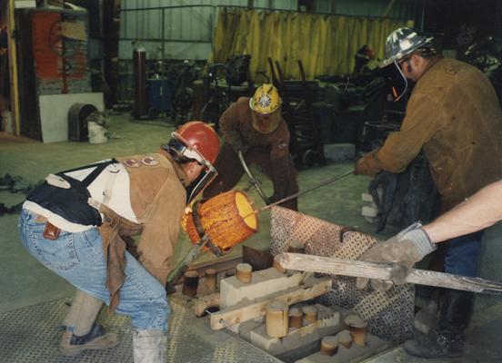 Scott Oberlink, Andrew Marsh and Jack Gron pouring bronze at the University of Kentucky foundry for the casting of 