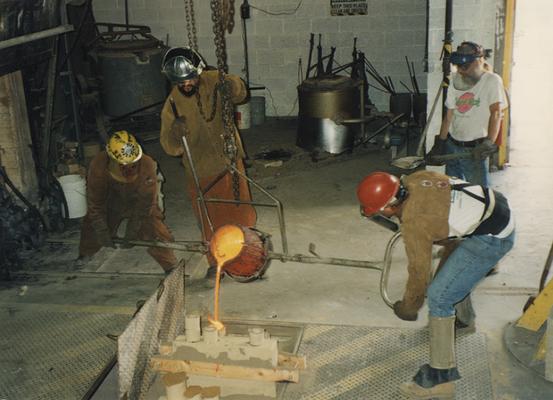 Andrew Marsh, Jack Gron, Scott Oberlink and an unidentified man pouring bronze at the University of Kentucky foundry for the casting of 