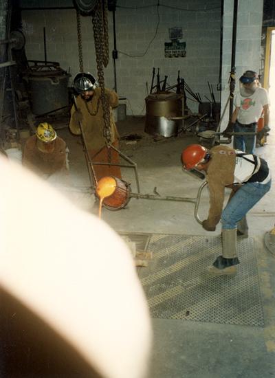 Andrew Marsh, Jack Gron, Scott Oberlink and an unidentified man pouring bronze at the University of Kentucky foundry for the casting of 