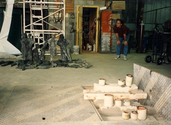 An unidentified man at the University of Kentucky foundry looking at the cast 