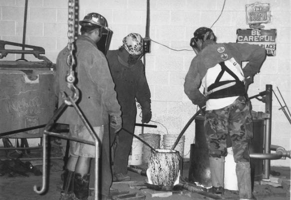 Jack Gron, Andrew Marsh and Scott Oberlink working with the crucible for the last cast at the University of Kentucky foundry of 