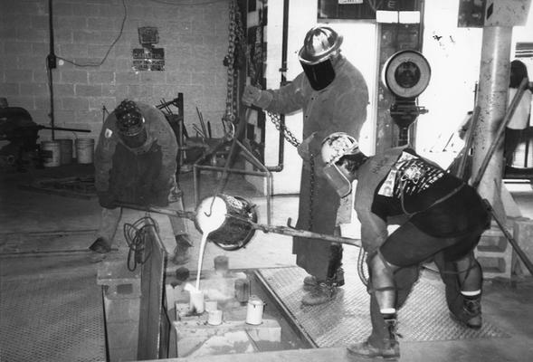 Scott Oberlink, Jack Gron and Andrew Marsh pouring bronze for the last cast at the University of Kentucky foundry of 