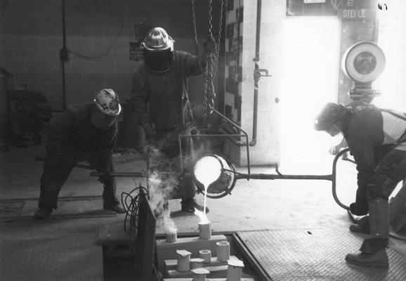 Andrew Marsh, Jack Gron and Scott Oberlink pouring bronze for the last cast at the University of Kentucky foundry of 