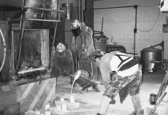 Andrew Marsh, Jack Gron and Scott Oberlink pouring bronze for the last cast at the University of Kentucky foundry of 