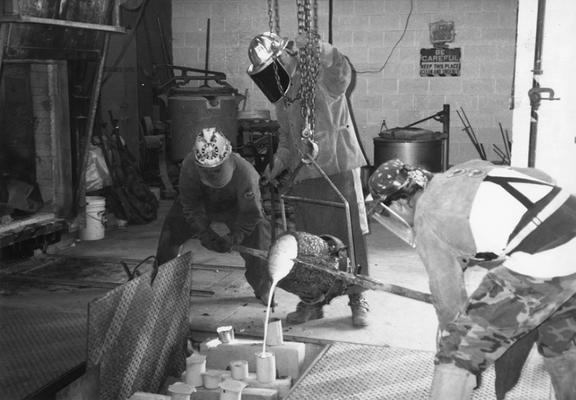 Andrew Marsh, Jack Gron and Scott Oberlink pouring bronze for the last cast at the University of Kentucky foundry of 