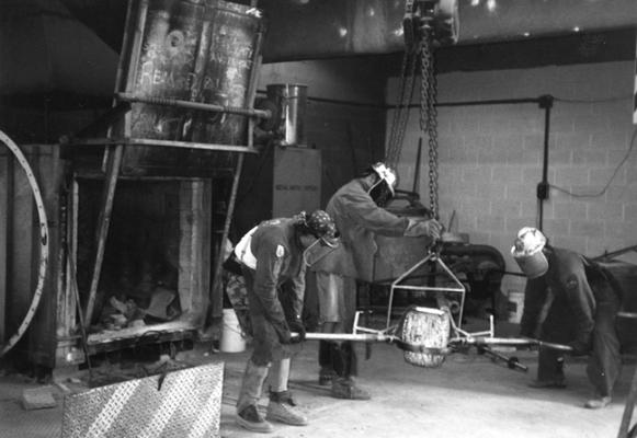 Scott Oberlink, Jack Gron and Andrew Marsh moving the crucible for the last cast at the University of Kentucky foundry of 