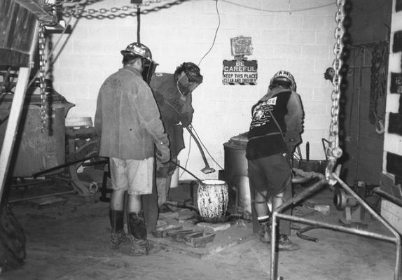 Jack Gron, Scott Oberlink and Andrew Marsh working with the crucible for the last cast at the University of Kentucky foundry of 