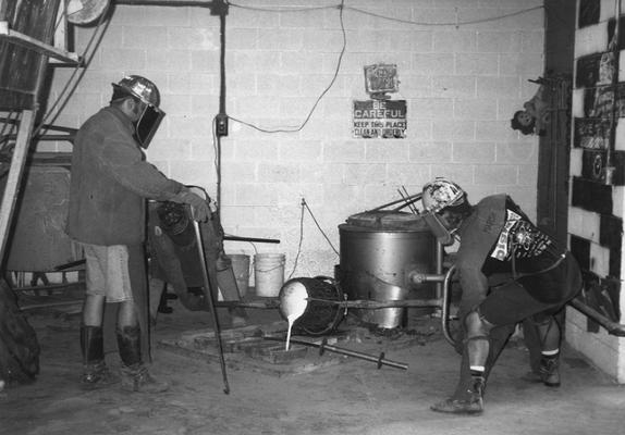 Jack Gron, Scott Oberlink and Andrew Marsh pouring out bronze from the last cast at the University of Kentucky foundry of 