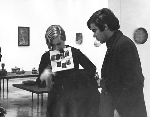 A woman and man at an exhibit entitled 