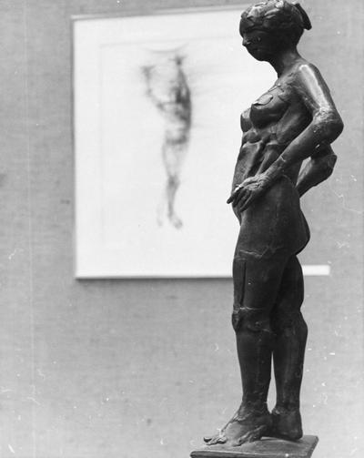 A bronze figure sculpture and an ink drawing entitled 