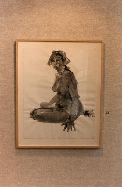 An ink wash drawing of a female nude in an exhibit entitled 