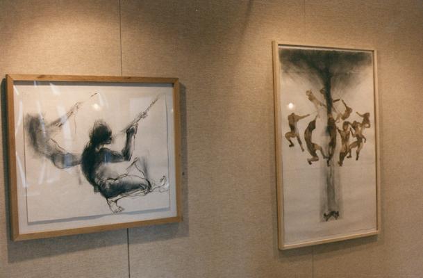 Two charcoal and ink drawings of human figures in an exhibit entitled 