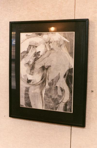 An ink wash drawing of two female nudes in an exhibit entitled 