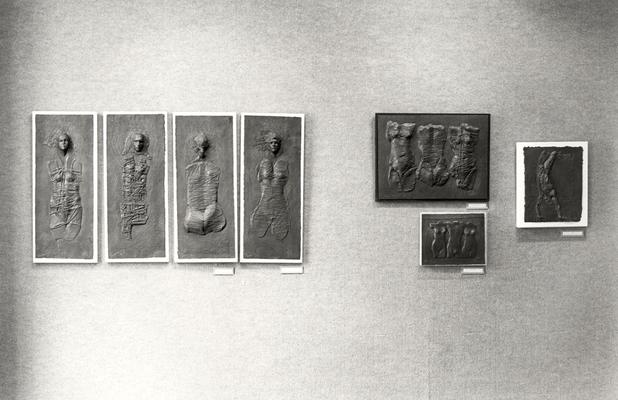 Seven cast paper sculptures of human figures, including 