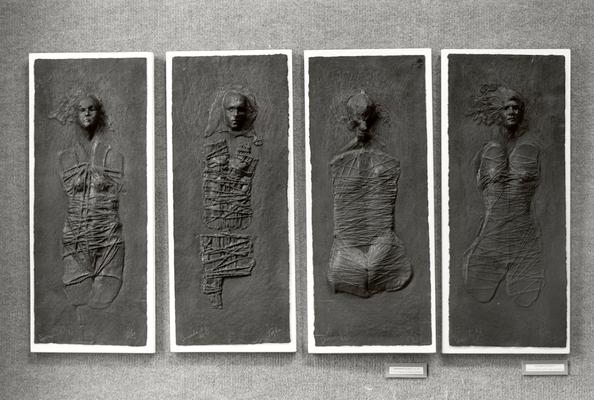 Four cast paper sculptures of human figures entitled 