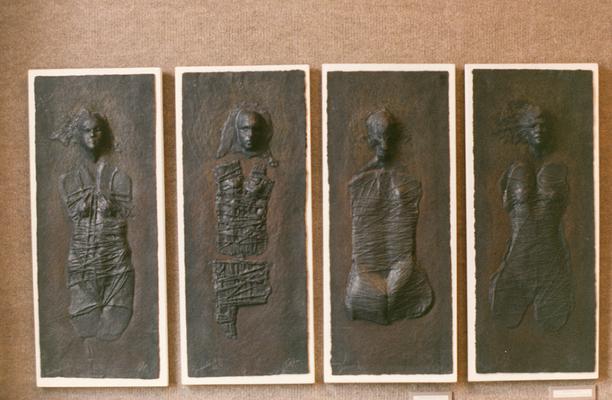 Four cast paper sculptures of human figures entitled 