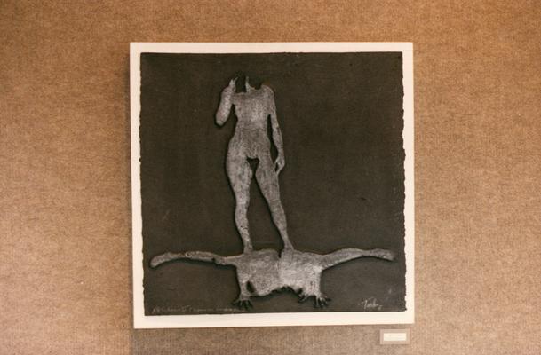 A cast paper sculpture of two human figures in an exhibit entitled 