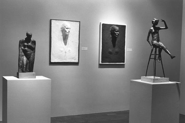 An image of two clay reliefs and two sculptures, including the bronze entitled 