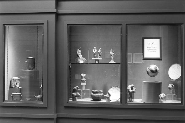 An image of multiple ceramic pots, sculptures and plates in an exhibit case at the 