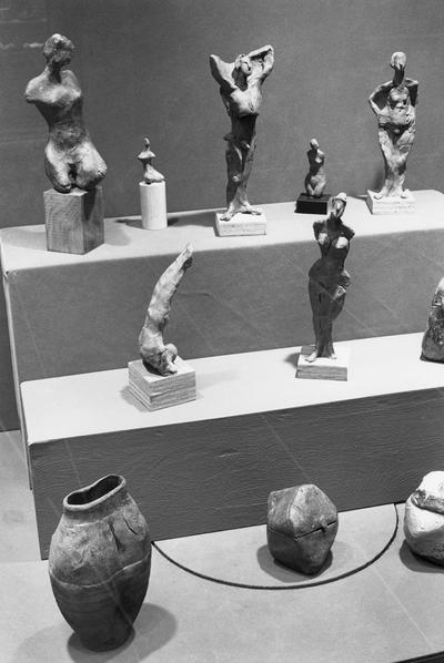 An image of multiple ceramic sculptures and pots in an exhibit case at the 