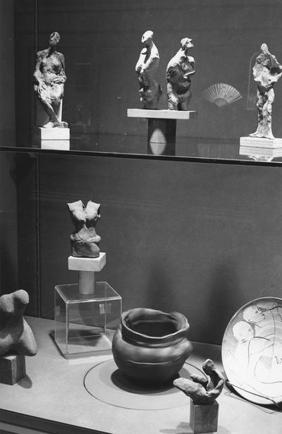 An image of ceramic figure sculptures and pottery in an exhibit case at the 