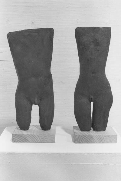 Two ceramic sculptures of a female and male torso in the 