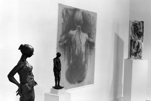 Two bronze sculptures of a female nudes, a drawing of a female nude, and a clay relief in the 
