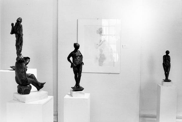 Four bronze figure sculptures and a drawing of a female nude in the 