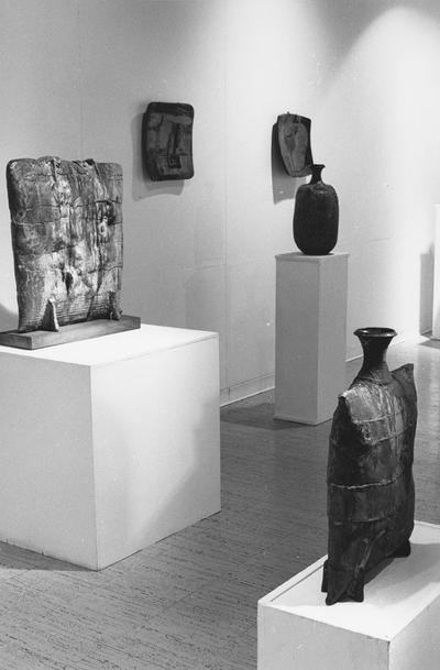 Three ceramic vessels and two clay reliefs in the 