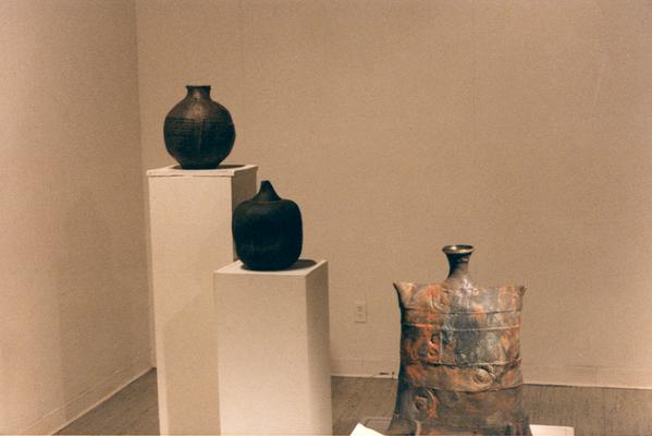 An image of a ceramic pouch vessel and two spherical shaped ceramic vessels in the 
