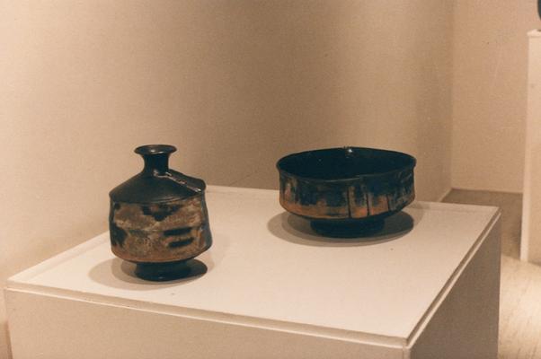 An image of a ceramic bowl and a ceramic vessel with a lid in the 