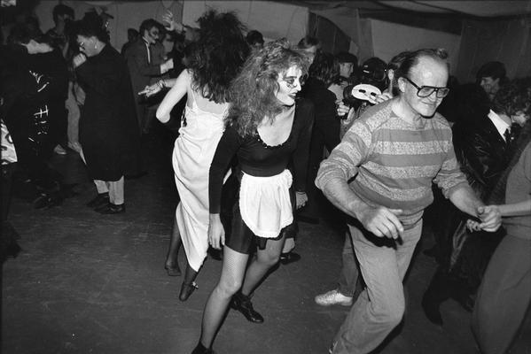 A image of John Tuska dancing with a group of unidentified persons at a costume party
