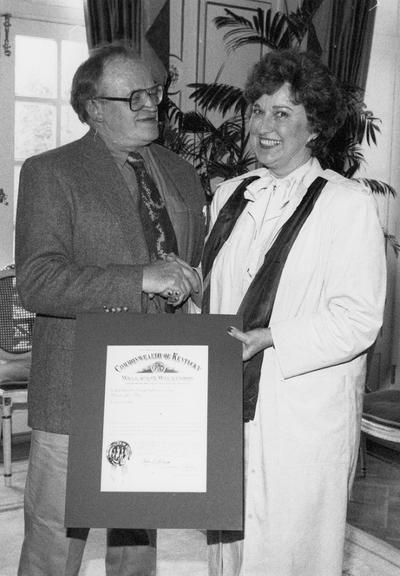 A image of John Tuska and an unidentified woman receiving a Kentucky Colonel Certificate
