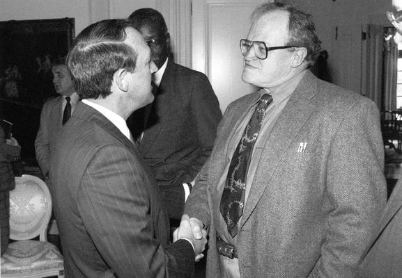 A image of John Tuska and Governor Wallace Wilkinson shaking hands at the award ceremony after receiving a Kentucky Colonel Certificate