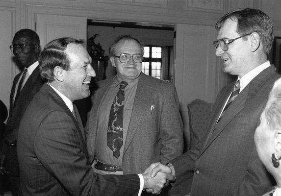A image of John Tuska with Governor Wallace Wilkinson and, Mayor of Lexington, Scotty Baesler shaking hands at the award ceremony for Kentucky Colonel Certificates