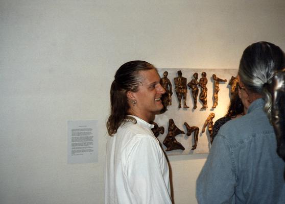 A image of Andrew Marsh and unidentified persons viewing artwork at the Heike Pickett Gallery
