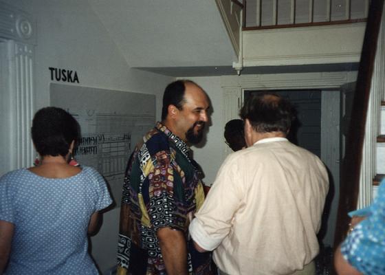 A image of Jack Gron, John Tuska and unidentified persons viewing artwork at the Heike Pickett Gallery