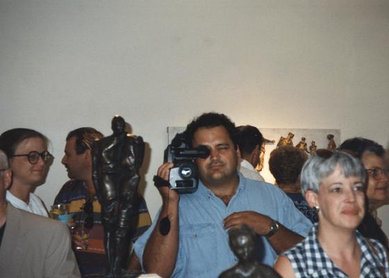 A image of Seth Tuska and unidentified persons viewing artwork at the Heike Pickett Gallery
