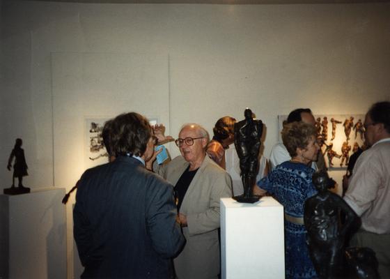 A image of John Tuska and unidentified persons viewing artwork at the Heike Pickett Gallery