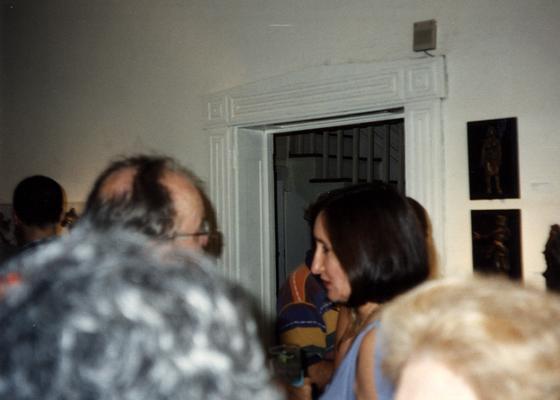 A image of John Tuska and unidentified persons viewing artwork at the Heike Pickett Gallery