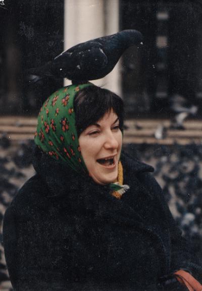 An image Miriam Tuska with a bird standing on her head