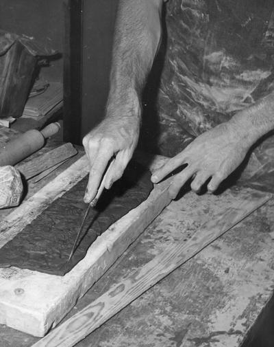 An image John Tuska cutting a textured slab of clay for a pot
