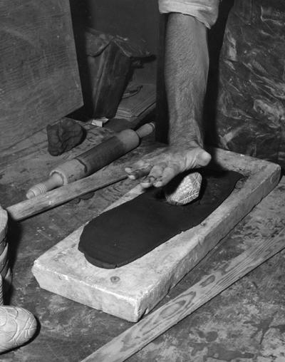 An image John Tuska texturing a slab of clay for a pot