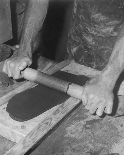 An image John Tuska rolling a slab of clay for a pot