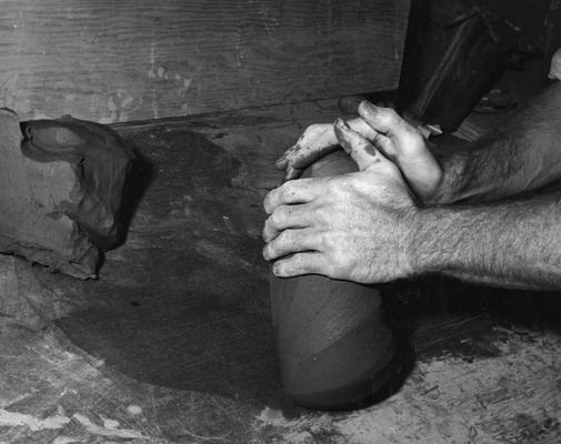 An image John Tuska wedging clay for a pot
