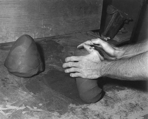 An image John Tuska wedging clay for a pot