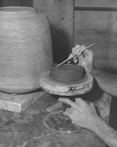 An image John Tuska making a coil pot