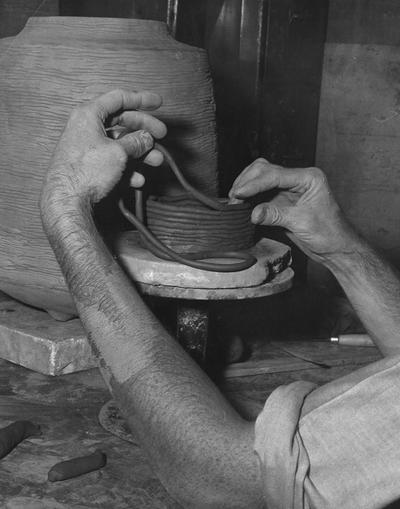 An image John Tuska making a coil pot