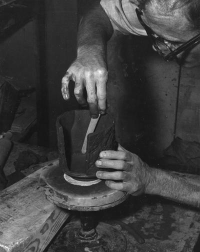 An image John Tuska attaching sides of a pot
